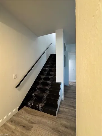 Stairs with hardwood / wood-style floors