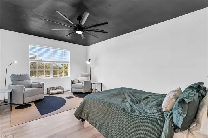 Bedroom with ceiling fan and light wood-type flooring