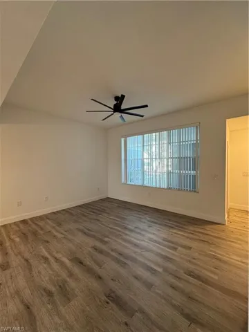Spare room with dark hardwood / wood-style floors and ceiling fan