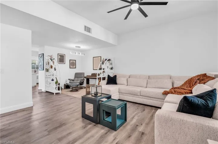 Living room featuring ceiling fan and hardwood / wood-style flooring