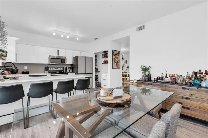 Dining room with sink and light hardwood / wood-style floors