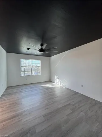 Unfurnished room with light hardwood / wood-style floors and ceiling fan