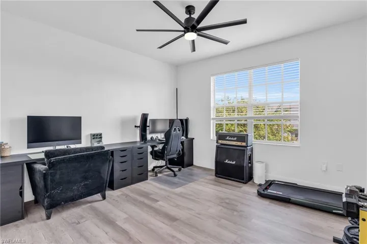 Office area featuring light wood-type flooring and ceiling fan