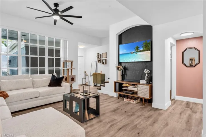 Living room featuring ceiling fan and hardwood / wood-style flooring