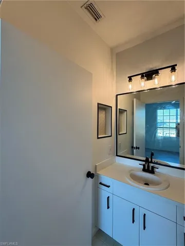 Bathroom with tile patterned flooring and vanity
