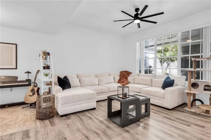 Living room with light hardwood / wood-style flooring and ceiling fan