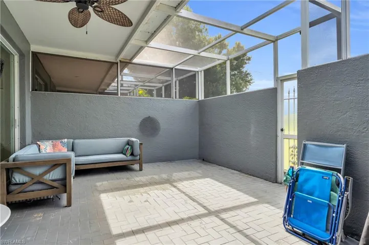 View of patio / terrace featuring ceiling fan and glass enclosure