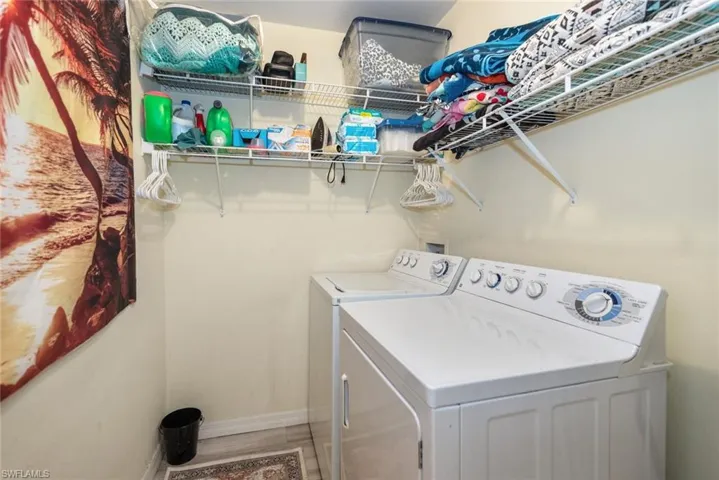 Laundry area with baseboards and washing machine and dryer