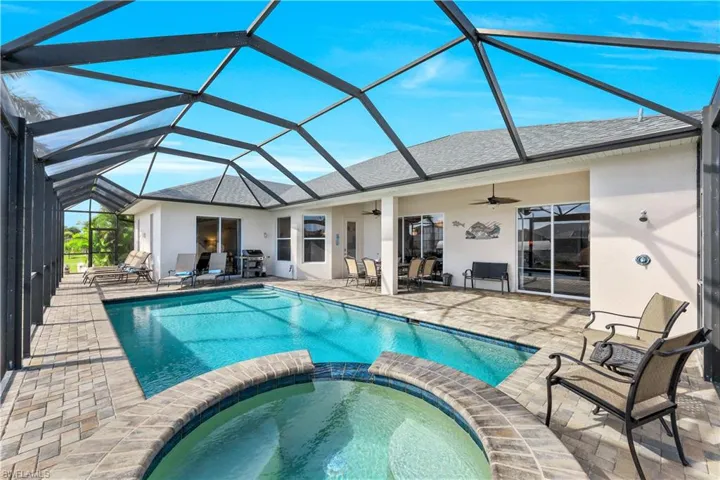 View of swimming pool with an in ground Poo; and spa a lanai, ceiling fan, and a patio area