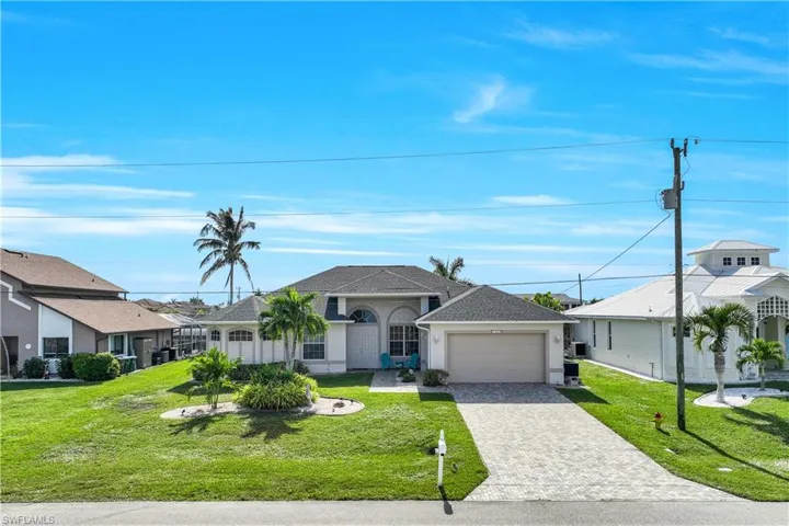 Ranch-style home with a front yard and a garage
