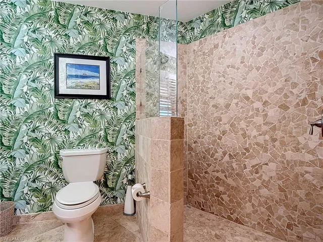 Bathroom featuring walk in shower and toilet