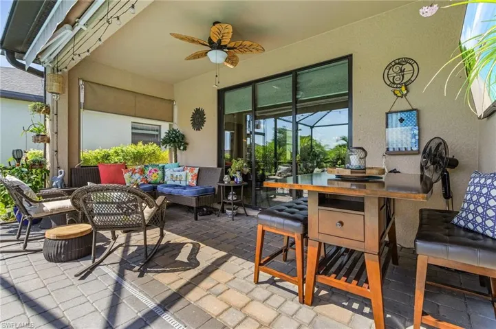 View of patio with ceiling fan and an outdoor hangout area