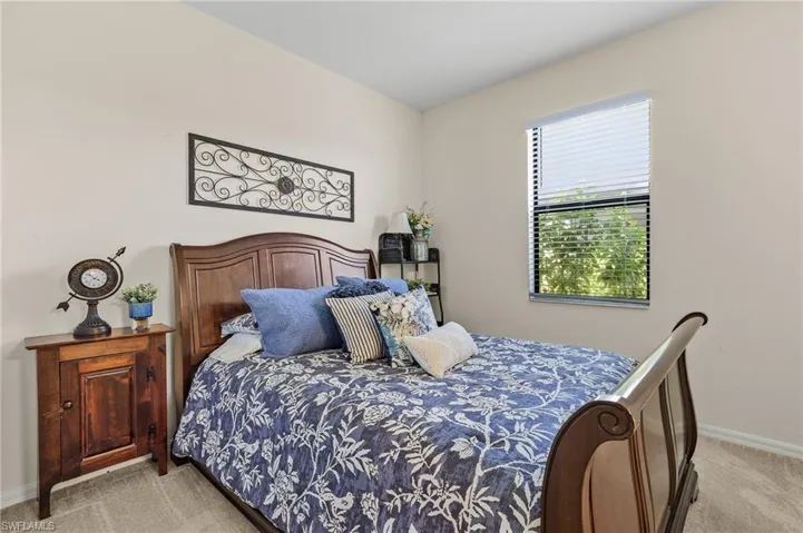 Bedroom featuring light carpet
