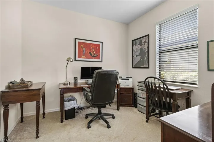 Office area featuring light carpet