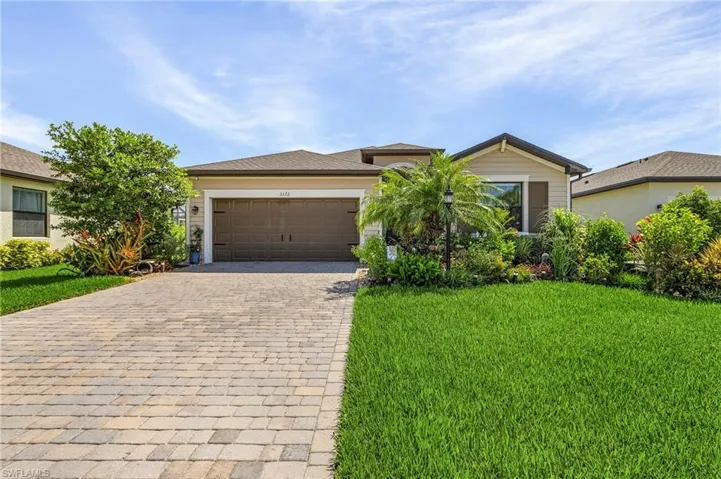View of front of house featuring a front yard and a garage