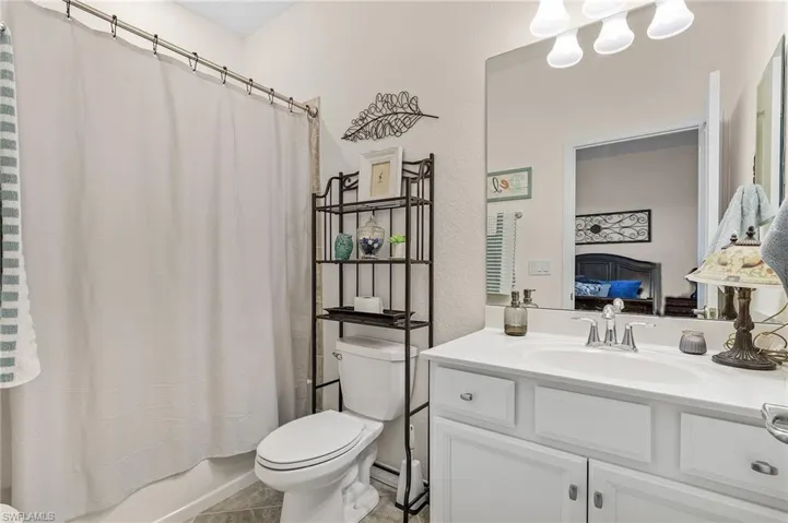 Bathroom featuring vanity, toilet, and tile patterned flooring