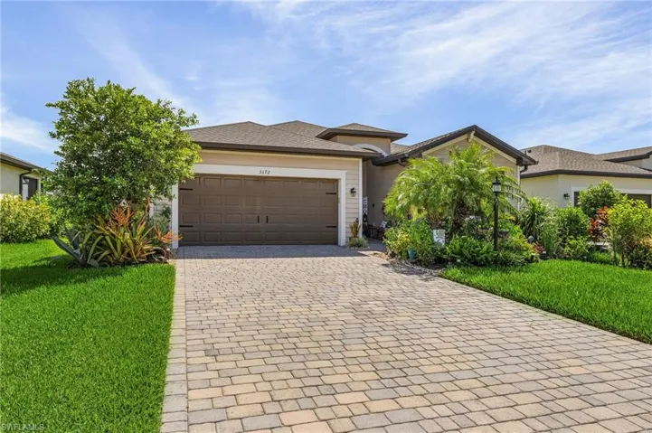 View of front of house with a front yard and a garage