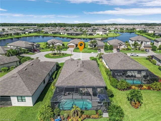Birds eye view of property with a water view