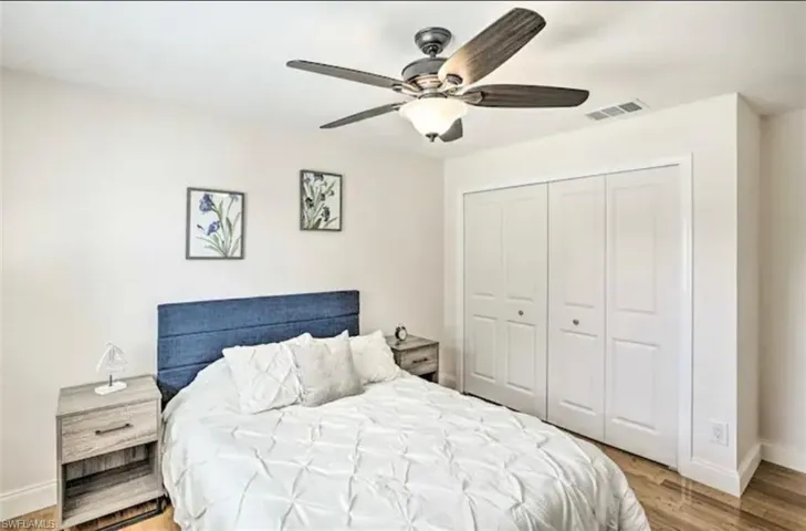 Bedroom featuring light wood-type flooring, a closet, and ceiling fan