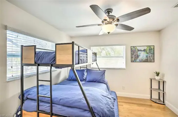 Bedroom with light wood-style flooring and ceiling fan