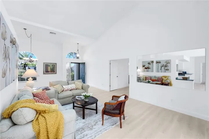Living area with wood finished floors and lofted ceiling