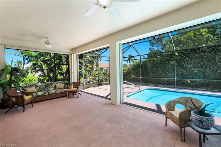 Outdoor pool with a patio area, a sunroom, a lanai, and outdoor lounge area