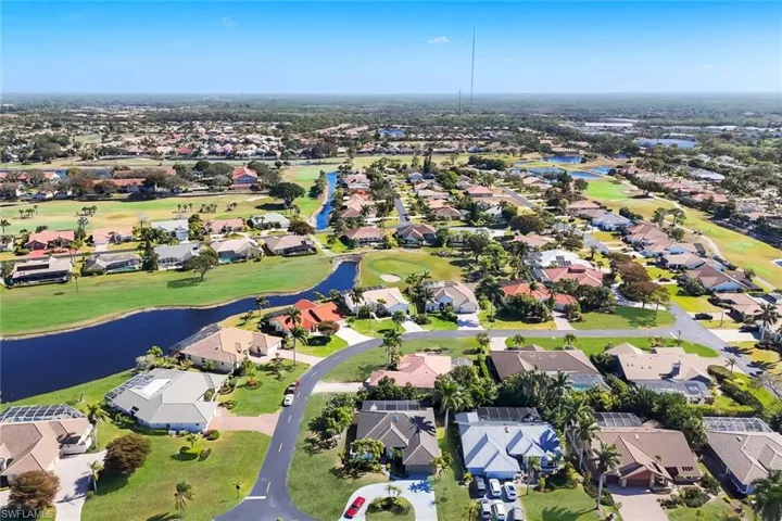 Aerial view of property's location with a large body of water and nearby suburban area