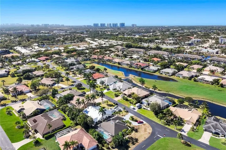 Aerial view of property and surrounding area with nearby suburban area and city skyline