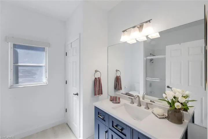 Full bath with vanity and shower / bath combination with glass door