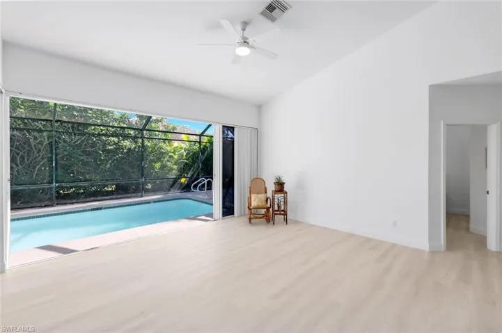 Swimming pool with a sunroom and ceiling fan