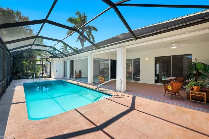 Outdoor pool with a sunroom, a lanai, and a patio area