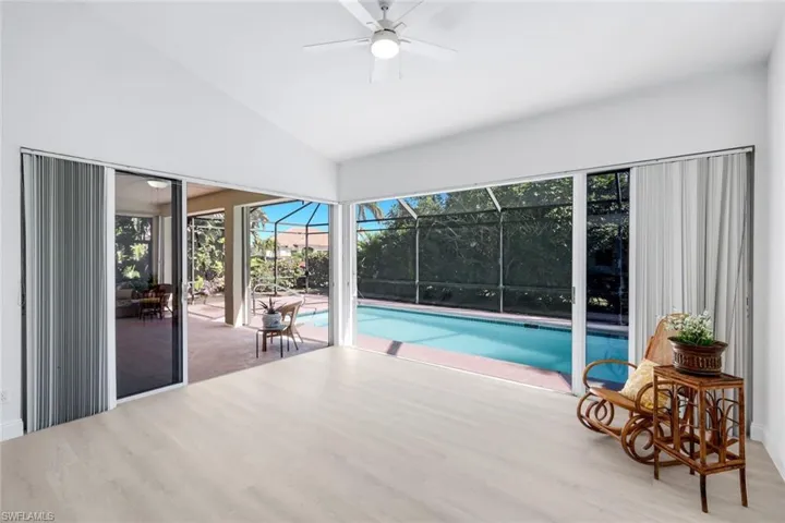 Swimming pool with a sunroom and ceiling fan