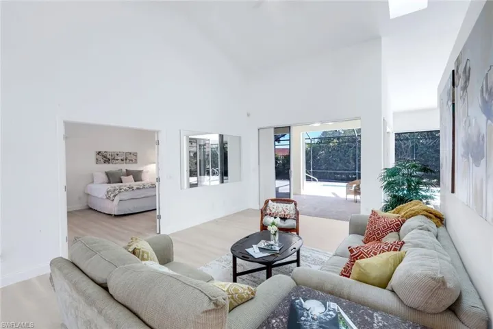 Living area with wood finished floors and vaulted ceiling