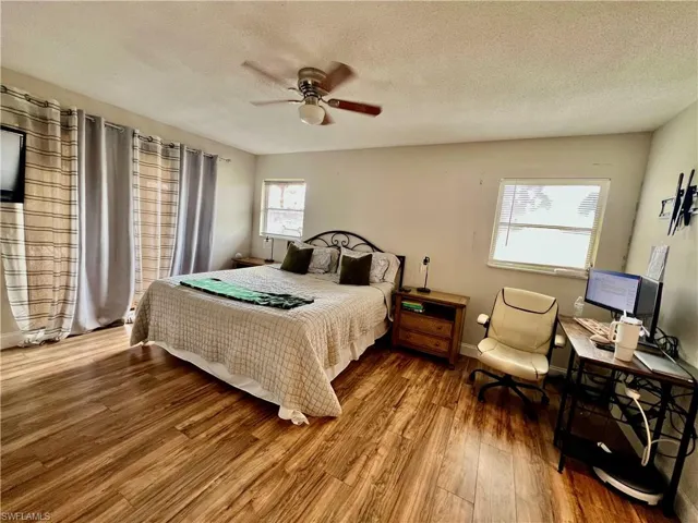 Primary bedroom with sliding door access to the pool area and private ensuite bathroom.