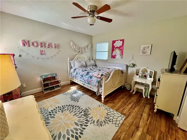 Bedroom featuring wood style flooring.