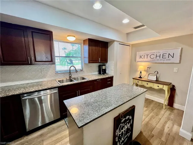 Kitchen with stainless steel appliances, sink, tile backsplash, a center island with GRANITE TOPS.