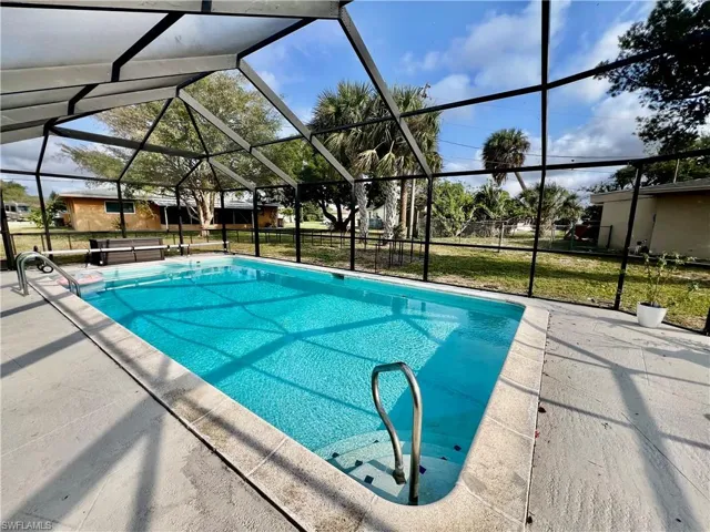 View of pool featuring a patio and new screen enclosure in 2020.