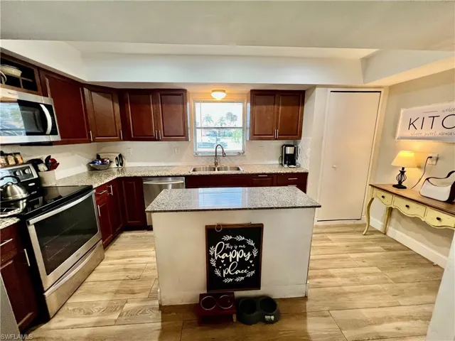 Kitchen with stainless steel appliances, sink, tile backsplash, a center island with GRANITE TOPS.