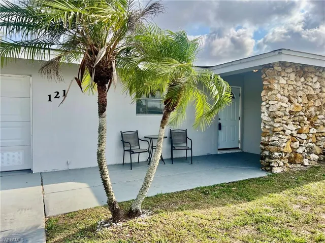 Doorway to property featuring a patio area