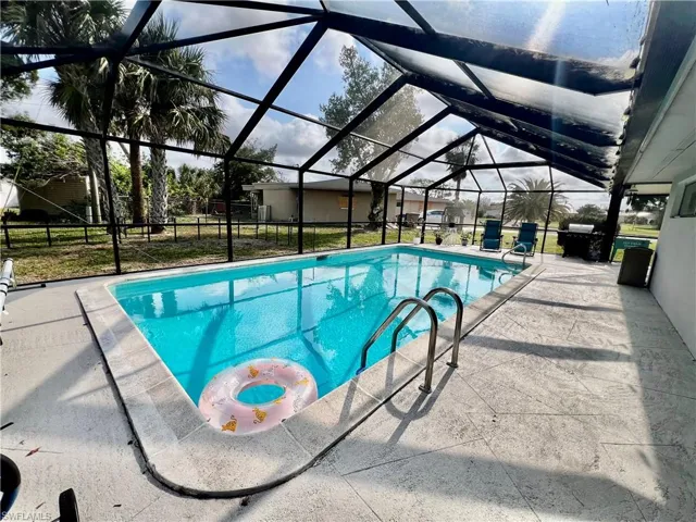 View of pool featuring a lanai and a patio area
