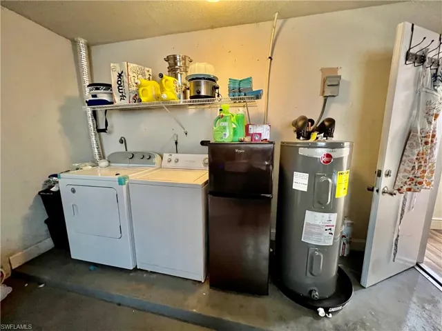 Laundry room featuring washing machine and dryer and electric water heater new in 2022.