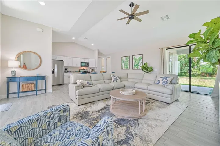 Living room with high vaulted ceiling and ceiling fan