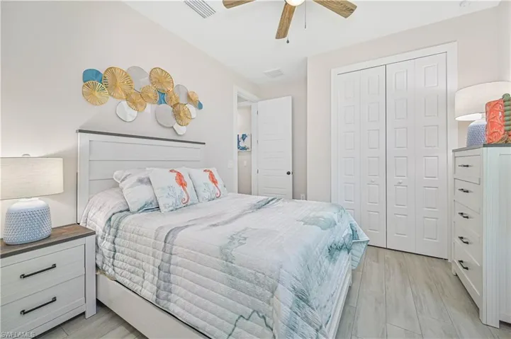 Bedroom featuring a closet, ceiling fan, and light hardwood / wood-style flooring