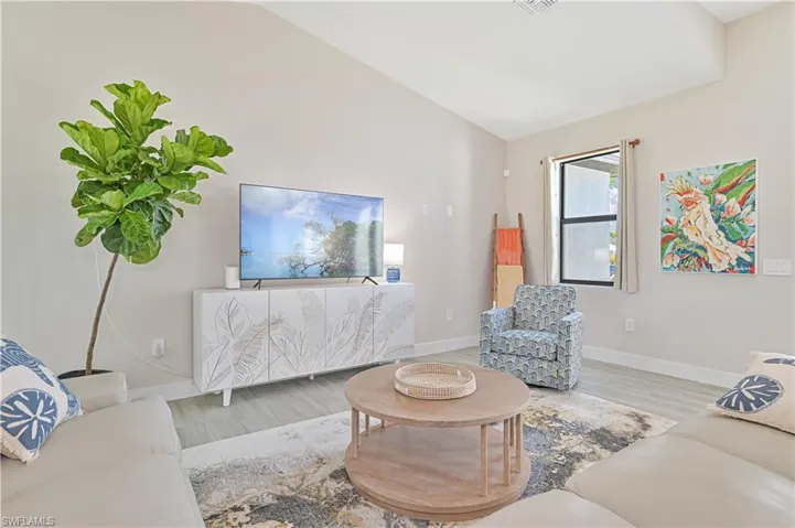 Living room featuring lofted ceiling and hardwood / wood-style floors