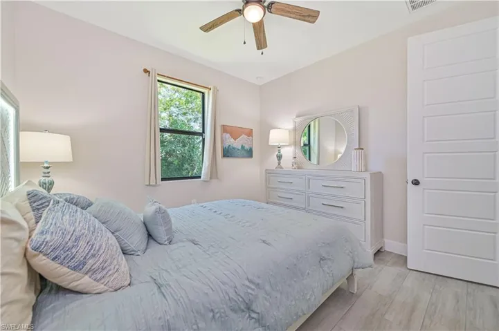 Bedroom featuring ceiling fan and light wood-type flooring