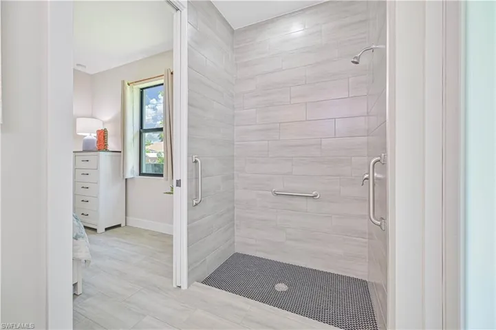 Bathroom featuring walk in shower and tile floors