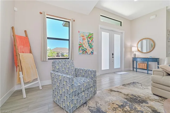Sitting room with wood-type flooring and french doors