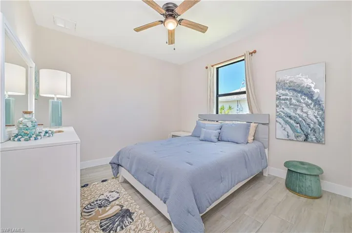 Bedroom featuring ceiling fan and light hardwood / wood-style flooring