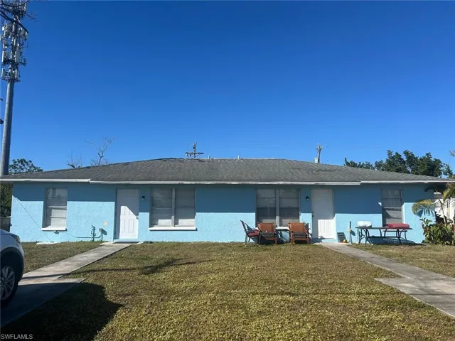 View of front of home featuring a front lawn and stucco siding