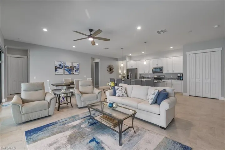 Living area with recessed lighting and ceiling fan